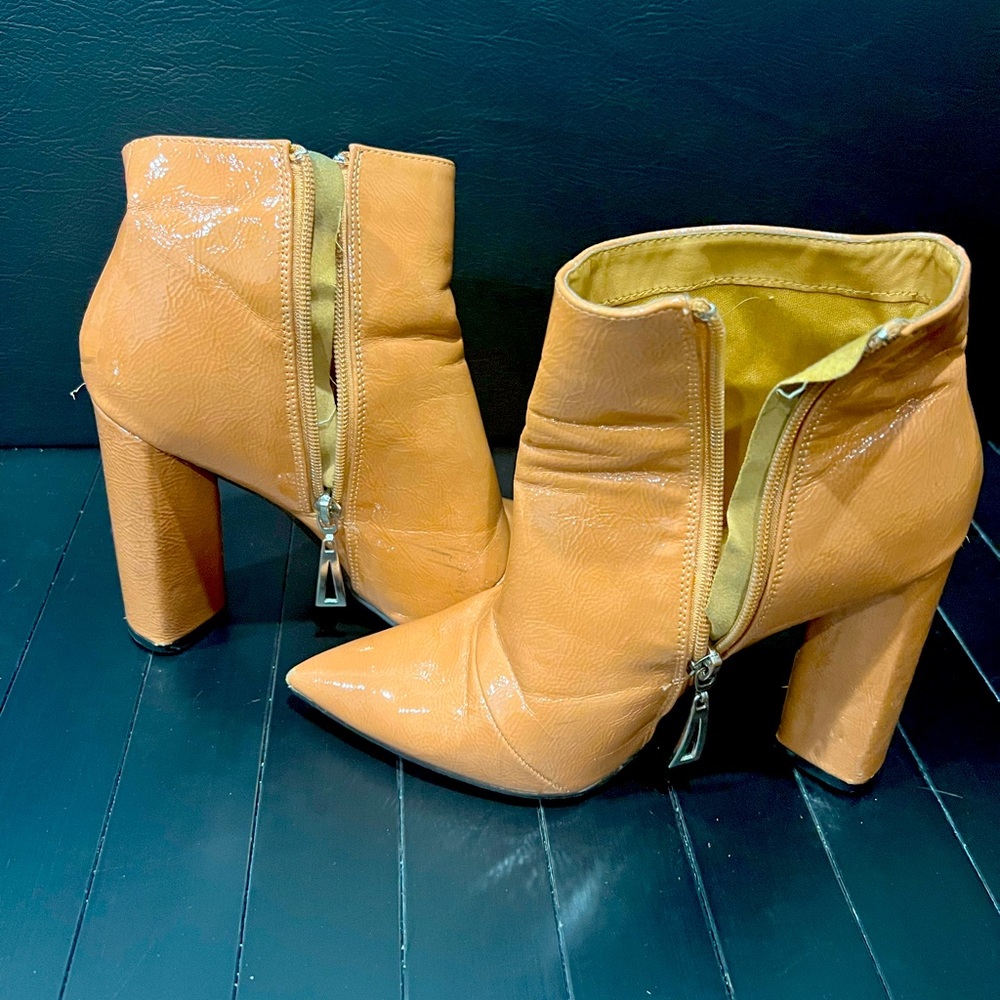 Cream/light pink colored bootie heels.